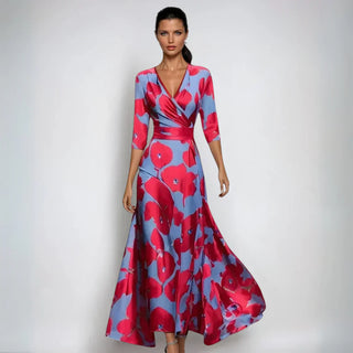Robe fleurie élégante Chloe, motif rouges sur fond bleu, ceinture nouée, manches 3/4.