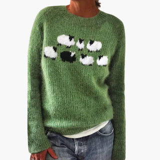 Pull vert à col rond, manches longues, motifs de pattes blanches et noires.