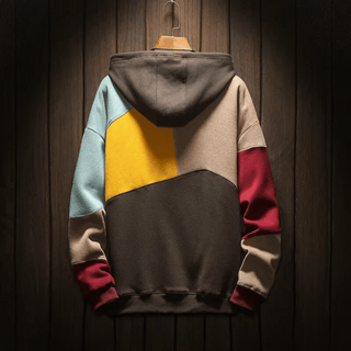 Sweat à capuche oversize patchwork, blocs bleu clair, beige, jaune et bordeaux.