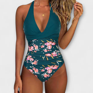 Maillot de bain une pièce femme bleu canard, décolleté en V, imprimé fleurs roses, taille froncée.