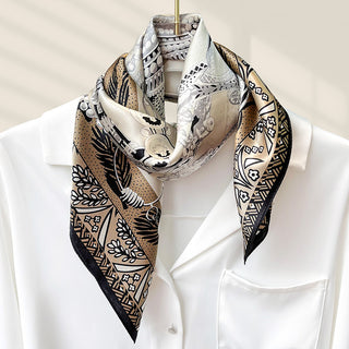 Carré de soie beige et noir à motifs feuillages et géométriques, bord marron.
