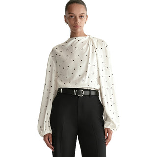 Blouse blanche à pois noirs, encolure froncée et manches bouffantes