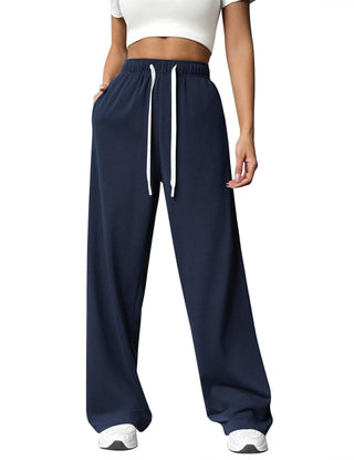 Pantalon de jogging femme taille haute bleu marine à cordon, jambe droite ample.