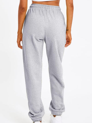 Pantalon de sport gris clair ample, élastique aux chevilles, vue arrière