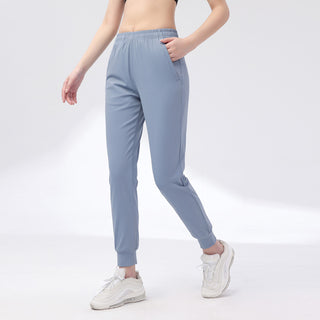 Pantalon de sport pour femme bleu-gris, taille élastique, poches latérales et chevilles resserrées