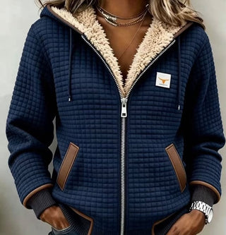 Veste bleu marine à capuche matelassée, poignets côtelés et poches à liseré brun