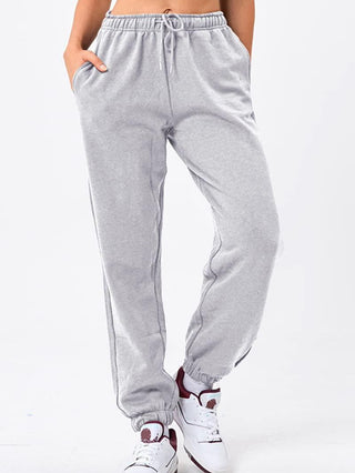 Pantalon de sport gris clair ample, taille smockée à cordon, bas resserré