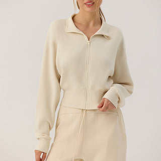 Veste zippée courte crème à col montant, zip central et manches ballon en jersey