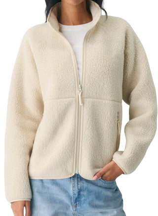 Veste polaire sherpa crème avec fermeture zippée et col montant, poches latérales