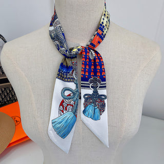 Foulard étroit blanc à motifs de clés et glands bleus, noué autour du cou