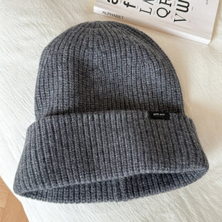 Bonnet en laine gris foncé, maille côtelée, revers large, étiquette noire