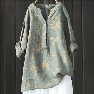 Blouse bleu-vert clair à motif floral ton sur ton, col en V, boutons.
