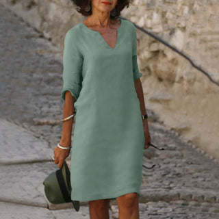Robe à col V vert clair, manches trois quarts, coupe droite.