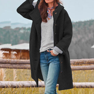 Manteau long en laine noir à boutons, manches longues, poches latérales visibles