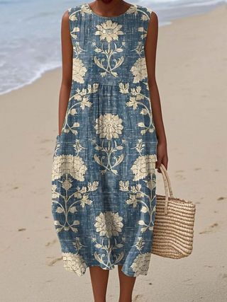 Robe sans manches bleue à fleurs, taille élastiquée et ourlet mi-mollet.